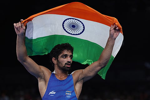 Men's 57kg free-style wrestling: Aman Sehrawat of India celebrates defeating Darian Toi Cruz of Puerto Rico 